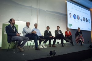 Panel discussion at the German Biochar Forum in Berlin. Multiple panel participants and a moderator discussing plant charcoal applications.